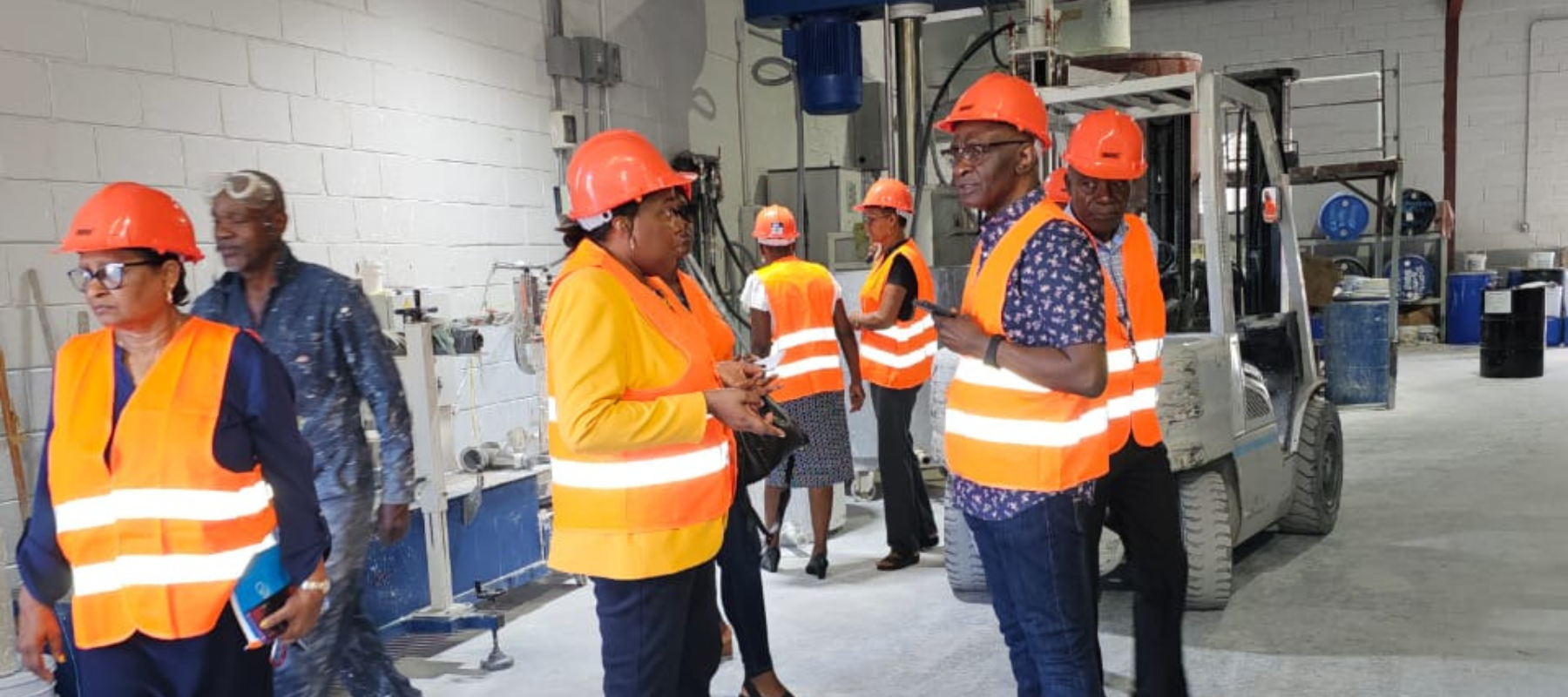 Antigua Government Officials in discussion at Harris Paints Factory in Antigua