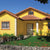 Exterior of a house in the Caribbean, painted bright yellow.
